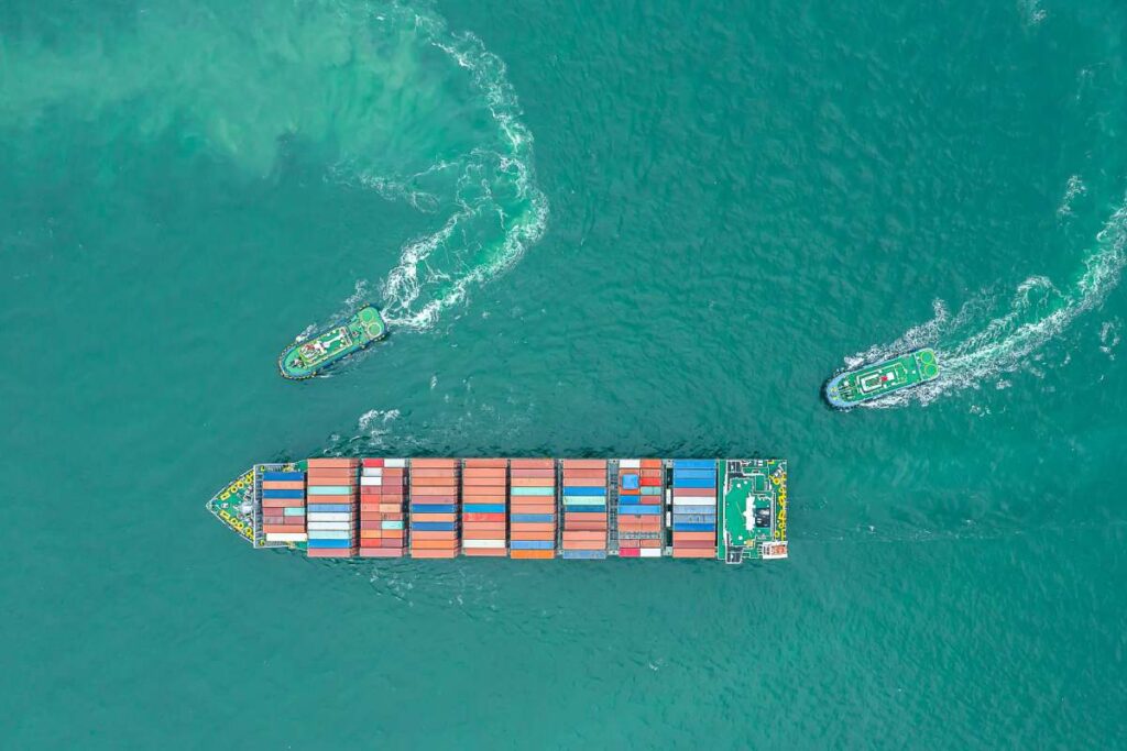 Aerial top view of cargo ship carrying container for import export goods  to customer,concept logistic and supply chain.