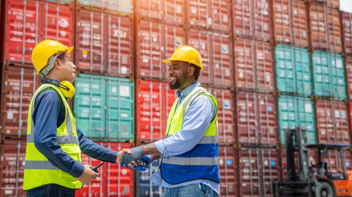 Engineering with worker team stack hands after checking or inspect many containers in stockyard,Success and winning concept.