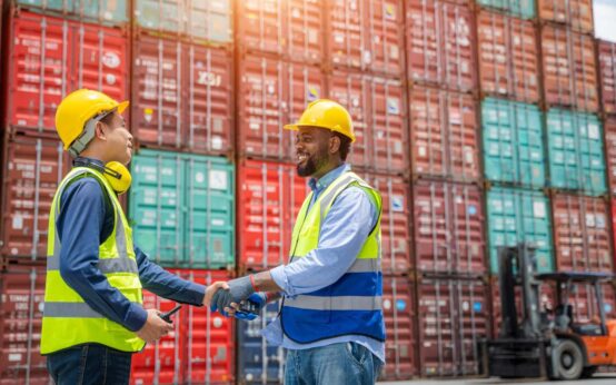 Engineering with worker team stack hands after checking or inspect many containers in stockyard,Success and winning concept.